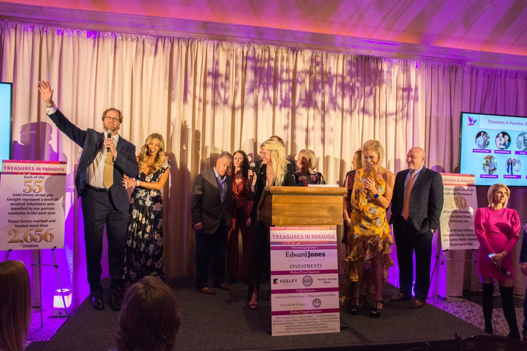 Kim Cella gives the introduction to the event among other speakers and co-chairs on stage at Treasures in Paradise